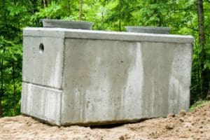 concrete structure for the septic system sitting above ground pre install